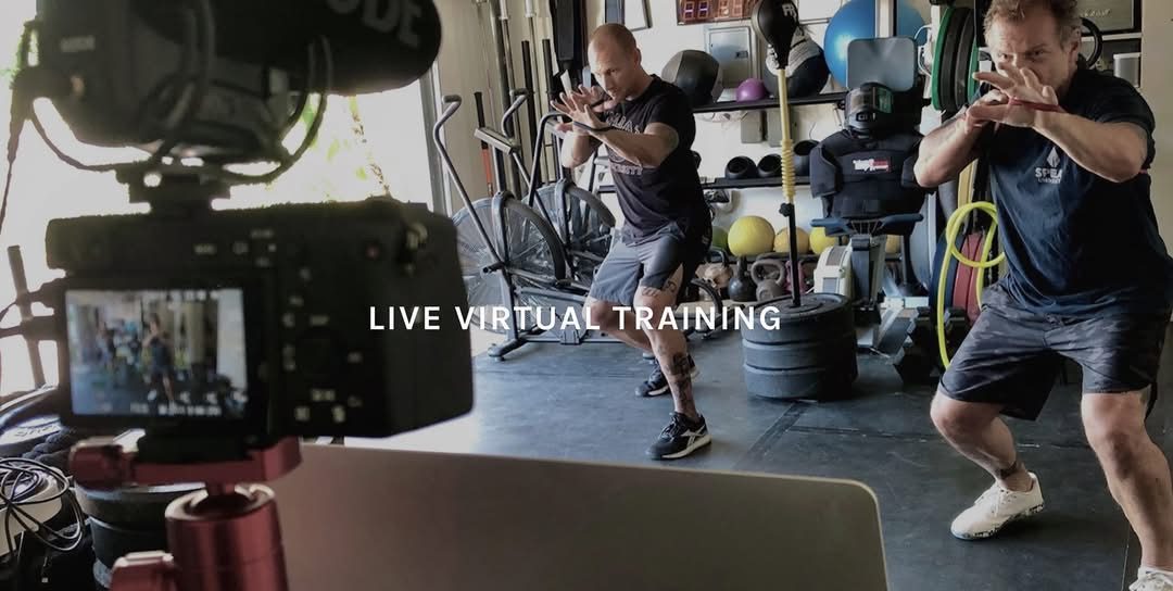 Camera filming a live virtual training session in a garage gym