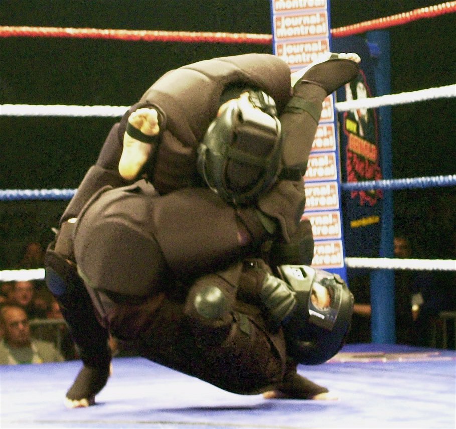 Two participants in full High Gear grappling during a live demonstration