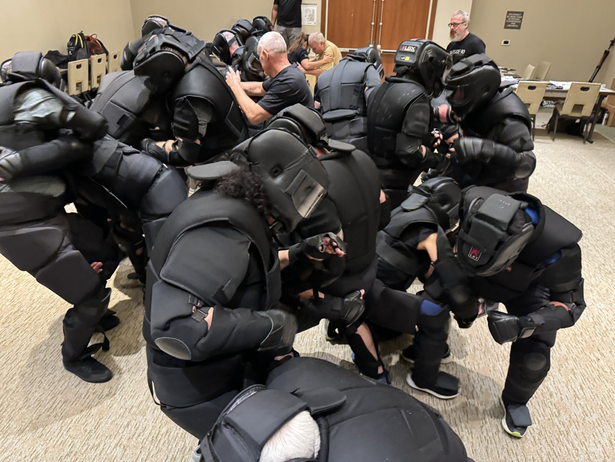 Students in High Gear impact-reduction suits running a group scenario drill