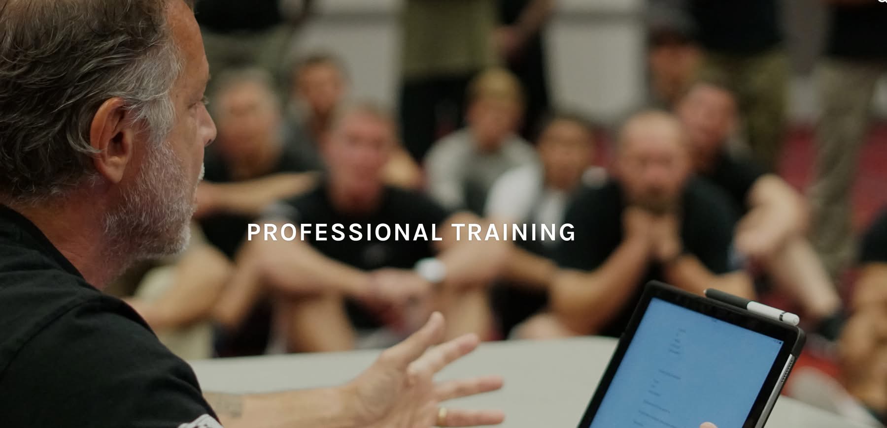Tony Blauer instructing a seated room of professional operators
